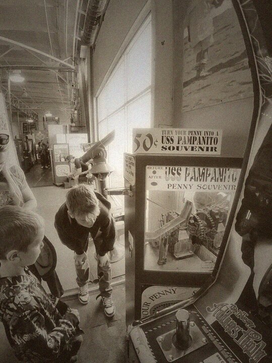 Junior Agent operating an antique arcade machine