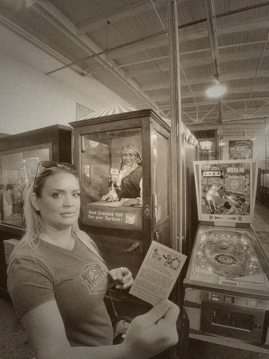 Night Shade holding a fortune card from an arcade machine