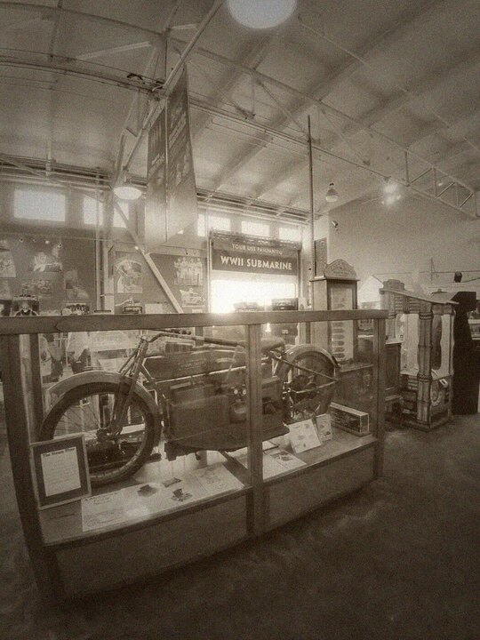 Antique motorcycle in a glass display case