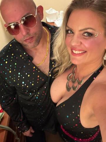 Commander and Night Shade posing together in a hotel room before going out
