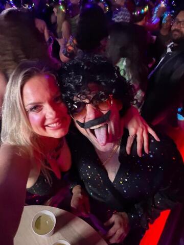Commander and Night Shade in a crowded club with other people visible behind them