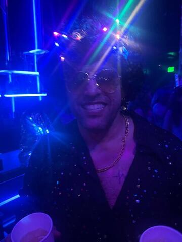Commander lit by blue laser beams in a dark club