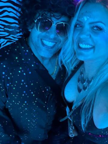 Commander and Night Shade taking a selfie against a blue zebra-print wall