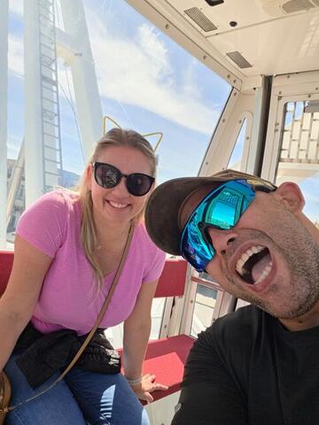 Commander laughing with his mouth wide open next to Night Shade in a Ferris wheel cabin