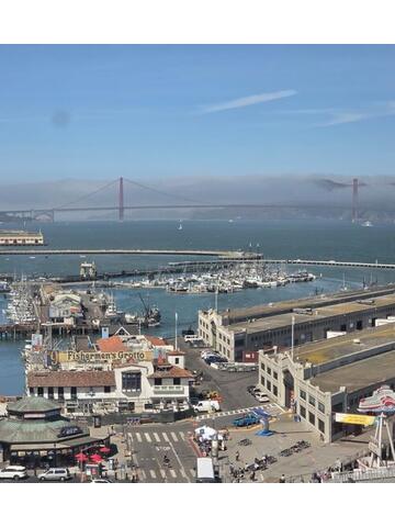View across a marina towards the Golden Gate Bridge in haze