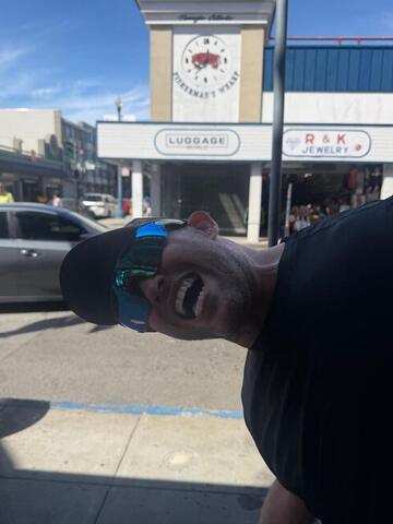 Commander leaning into the camera at close range blocking the view of a street